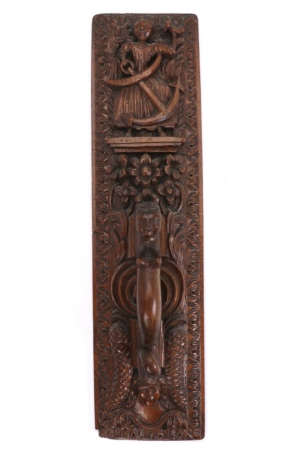 Walnut mangle board, dated 1774, from Schleswig-Holstein (Germany). The handle is in the shape of a mermaid and the board shows in high relief a woman holding an anchor in one hand and a dove in the other (Christian symbols of hope and the Holy Spirit)